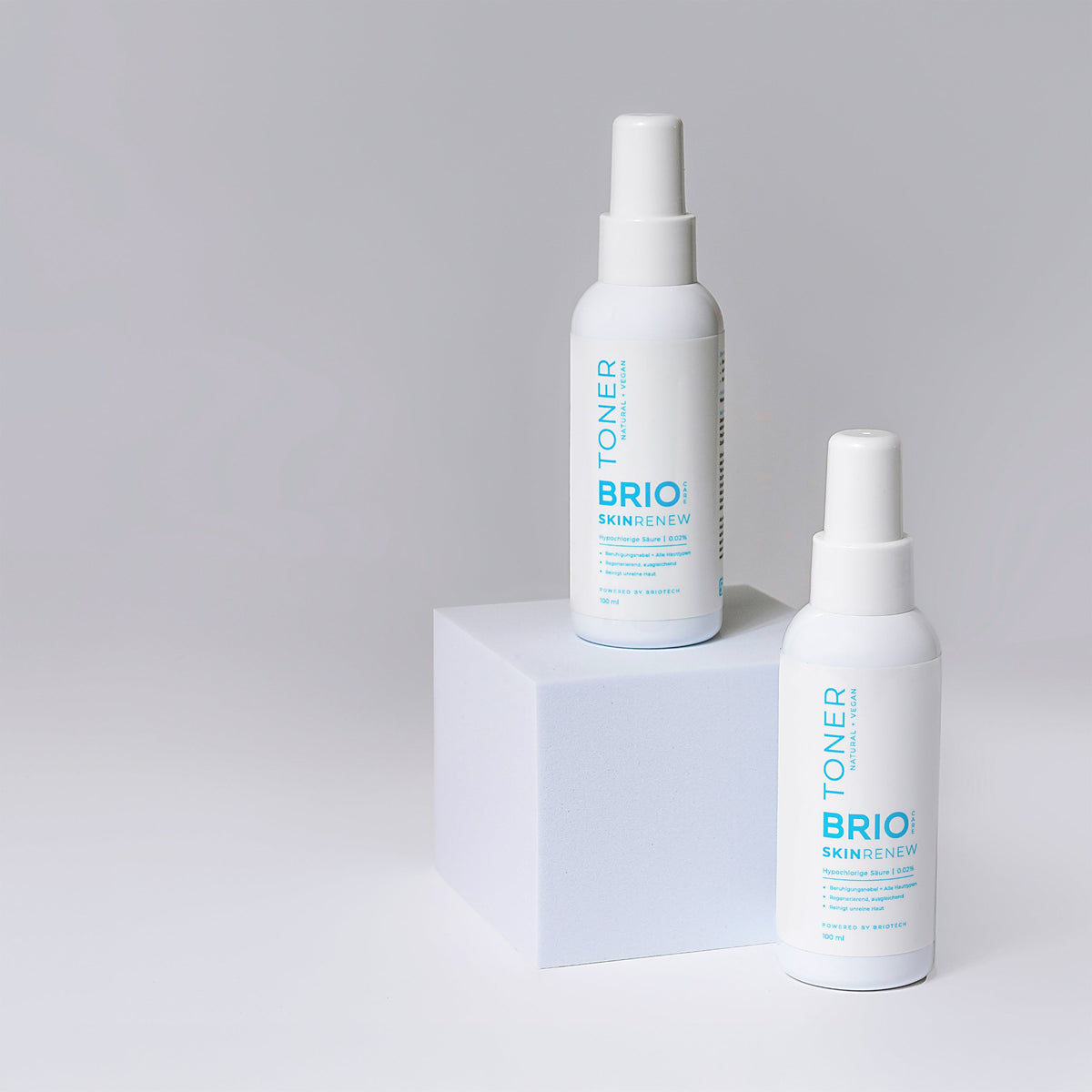 Two Skin Renew Toners on top of the table. Made with stable Briotech's Hypochlorous acid.