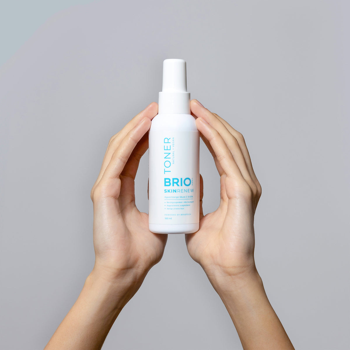 Hands holding a bottle of Skin Renew Toner which suitable for all skin types, even sensitive skin.